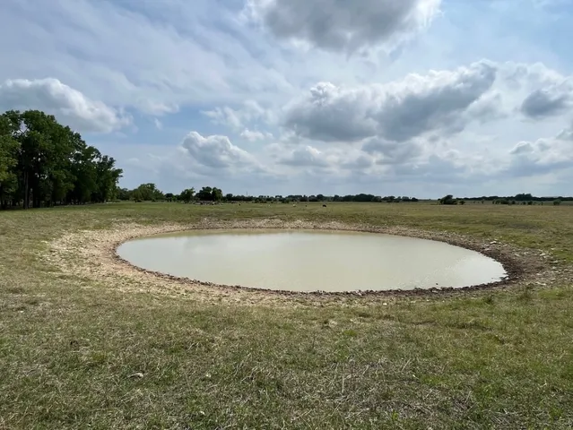 a view of a swimming pool and an outdoor seating