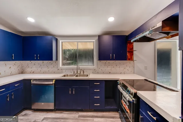 a kitchen with a sink and a refrigerator