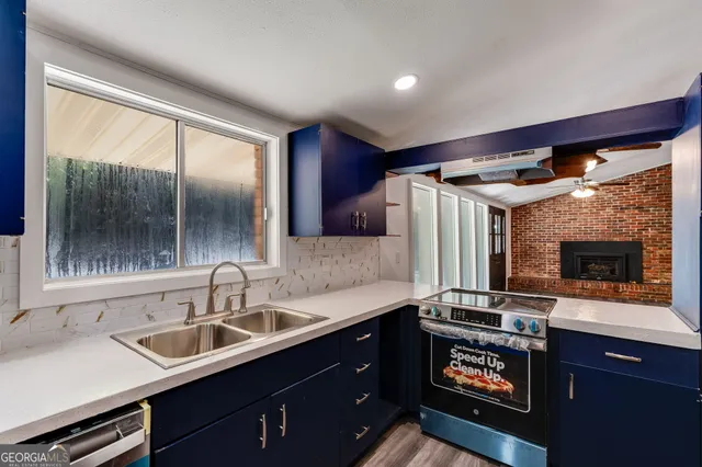 a kitchen with a sink and a refrigerator