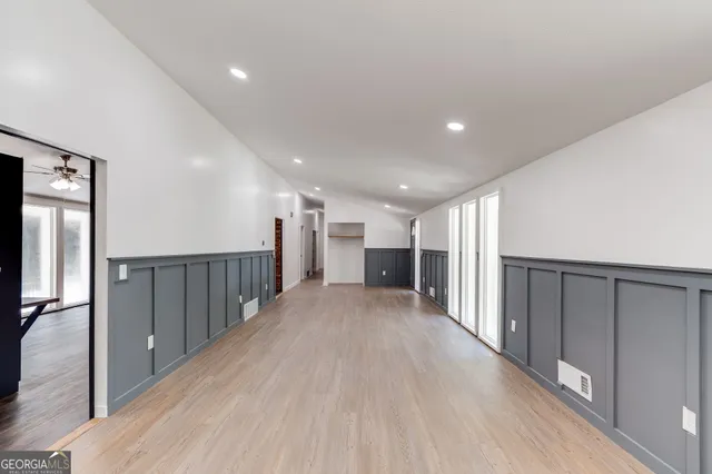 a view of a hallway with wooden floor
