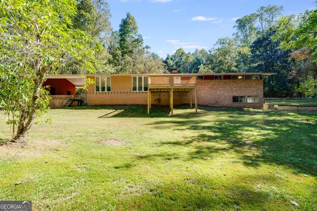 a backyard of a house with table and chairs