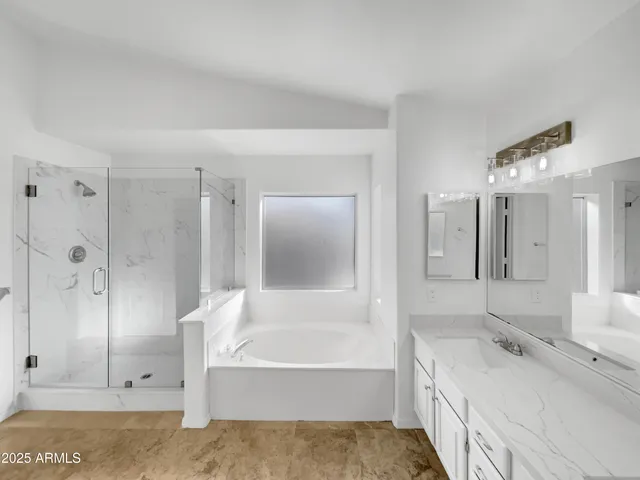 a bathroom with a tub sink and mirror
