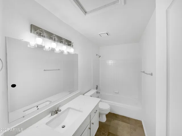a bathroom with a sink double vanity granite tub and shower