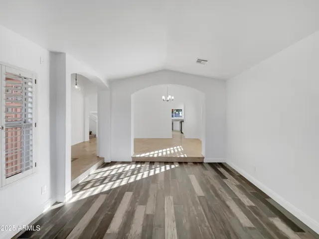 a view of a room with wooden floor and outdoor space