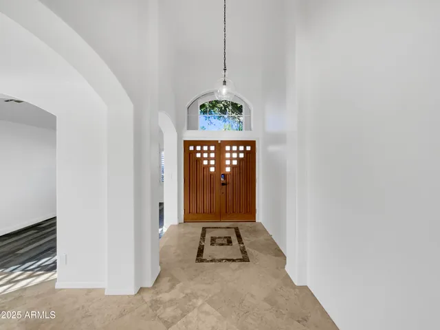 a view of an entryway door with chandelier