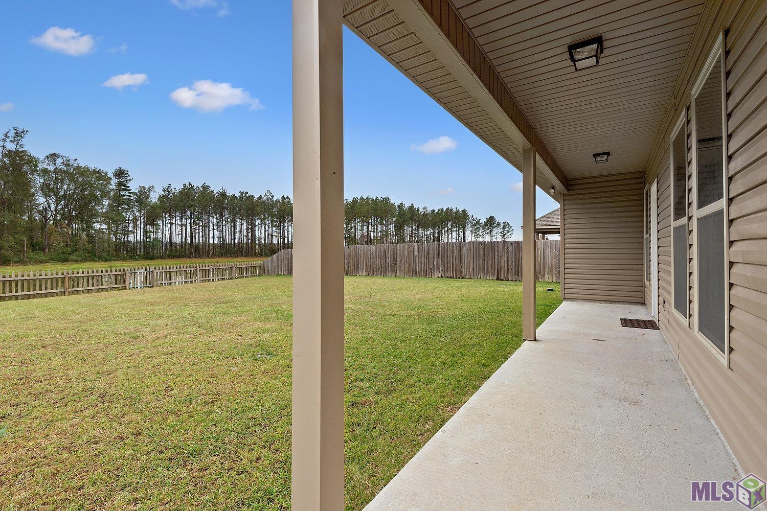 12304 Buddy Ellis Road Denham Springs, LA 70726 - Photo 9 of 10 Back porch/yard with lake view