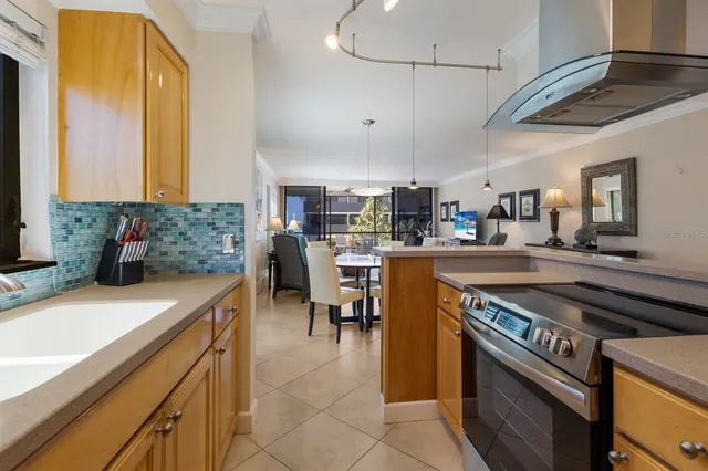 a kitchen with stainless steel appliances granite countertop a sink a stove and a refrigerator