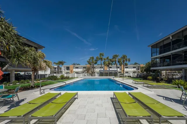 a swimming pool with outdoor seating and yard