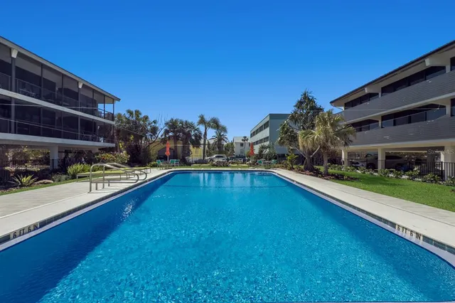 a view of a swimming pool with outdoor seating