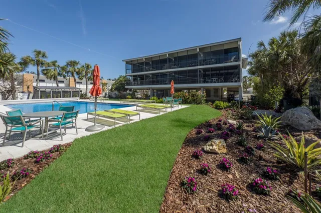 a view of a swimming pool with chairs