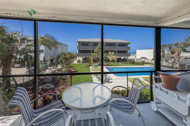 a dining room with furniture and a floor to ceiling window
