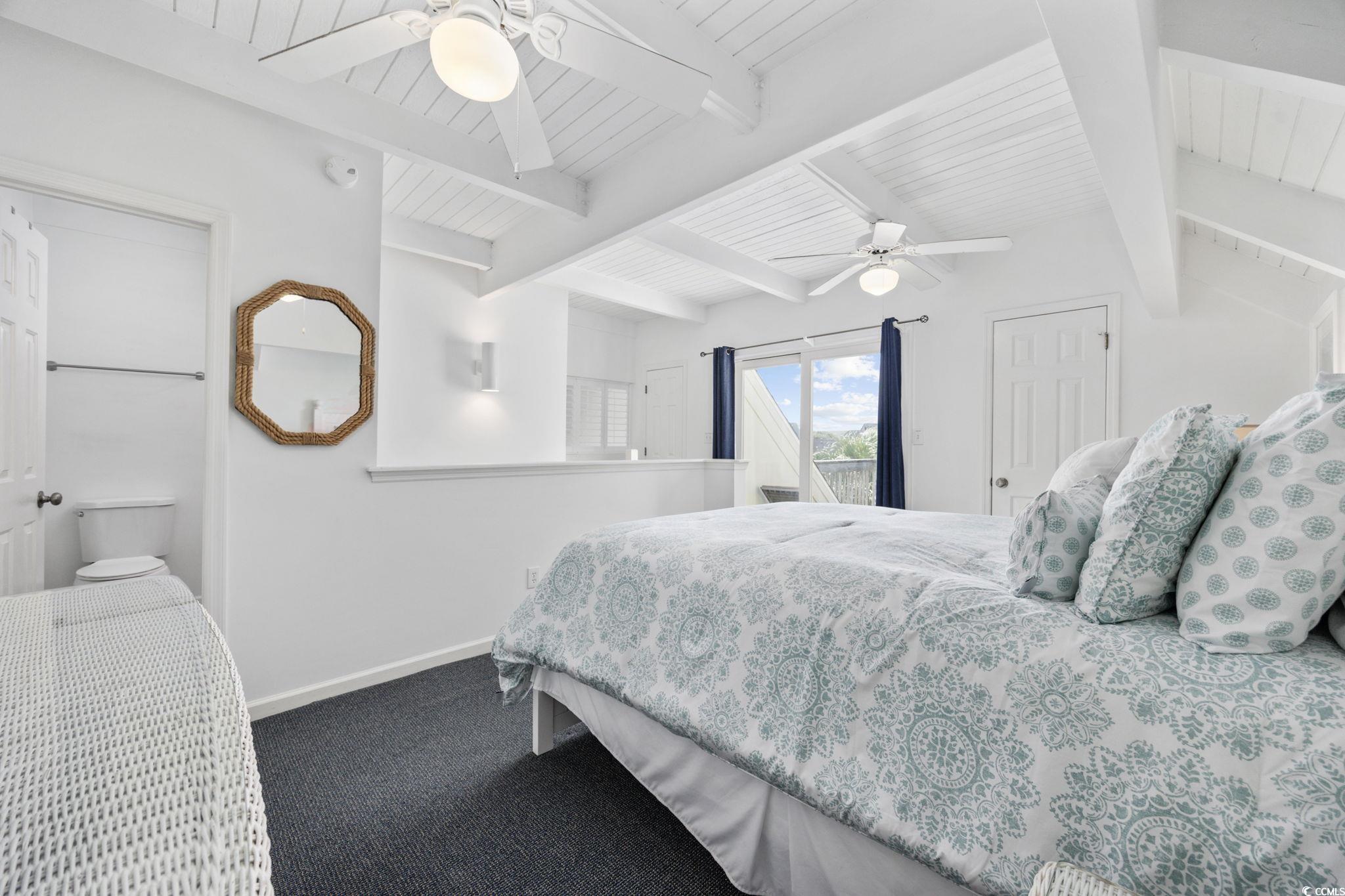 27 Riptide Lane Pawleys Island, SC 29585 - Photo 22 of 40 Bedroom with ceiling fan, beam ceiling, access to exterior, and dark colored carpet