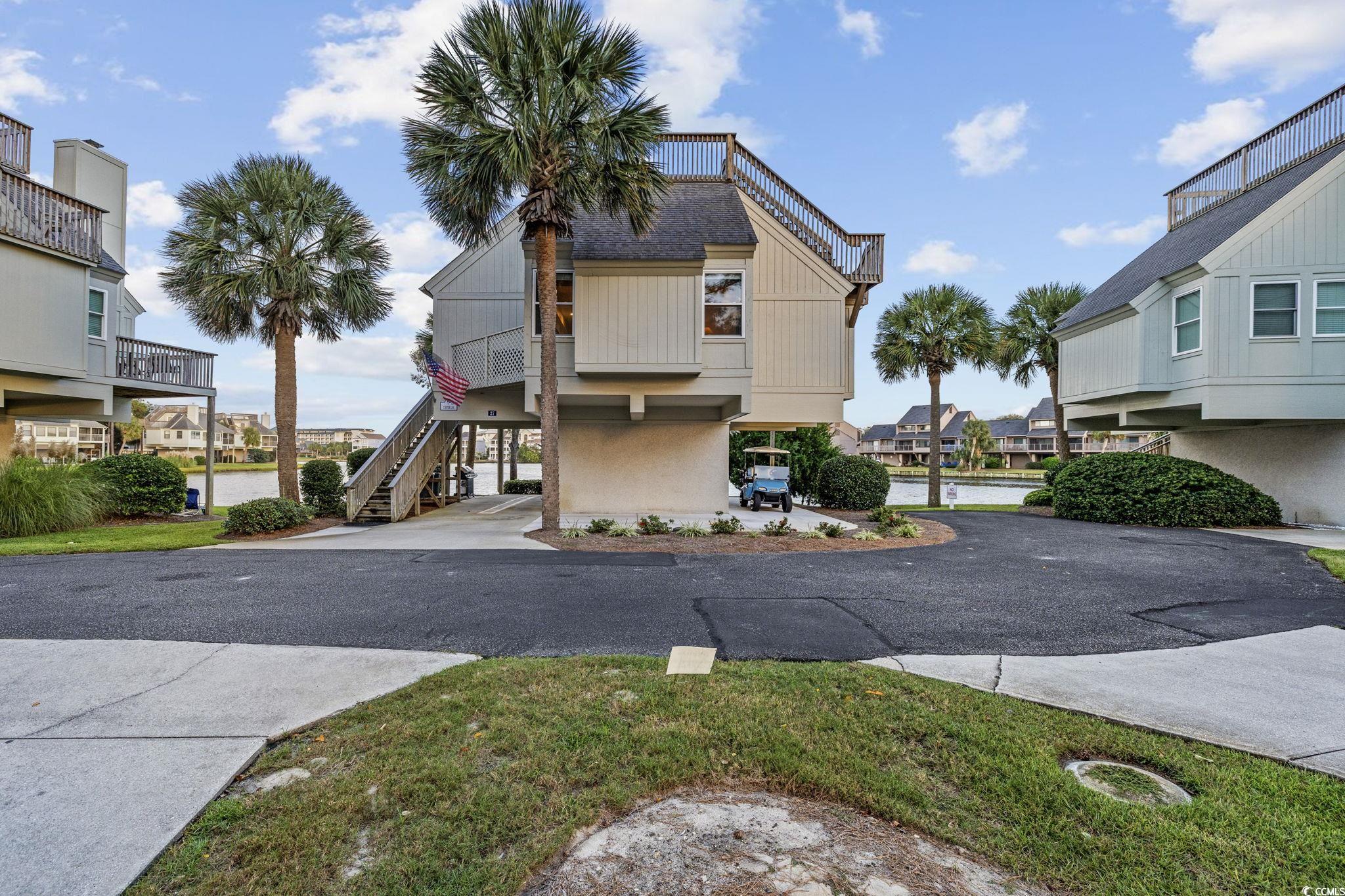 27 Riptide Lane Pawleys Island, SC 29585 - Photo 3 of 40 View of asphalt road featuring a residential view and stairway