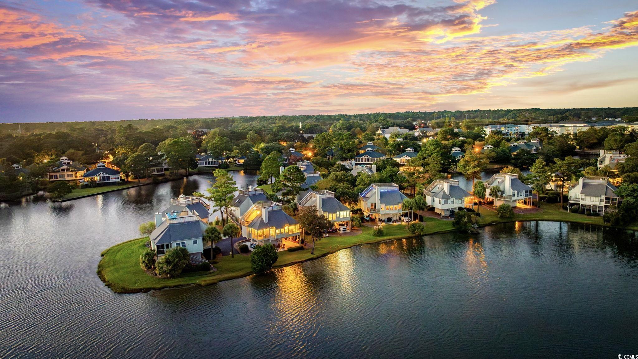 27 Riptide Lane Pawleys Island, SC 29585 - Photo 32 of 40 Aerial view at dusk of a residential view and a water view