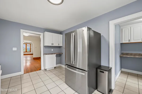 a kitchen with a refrigerator and a stove top oven