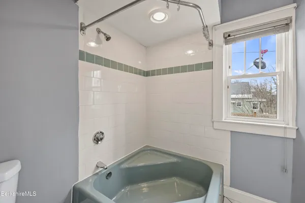 a bathroom with a tub and a shower