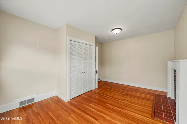 a view of room with wooden floor