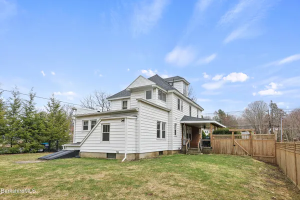 a house view with swimming pool in front of it