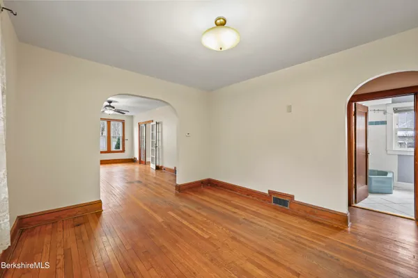 a view of empty room with wooden floor