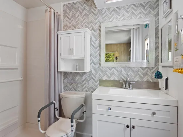 a bathroom with a sink toilet and mirror