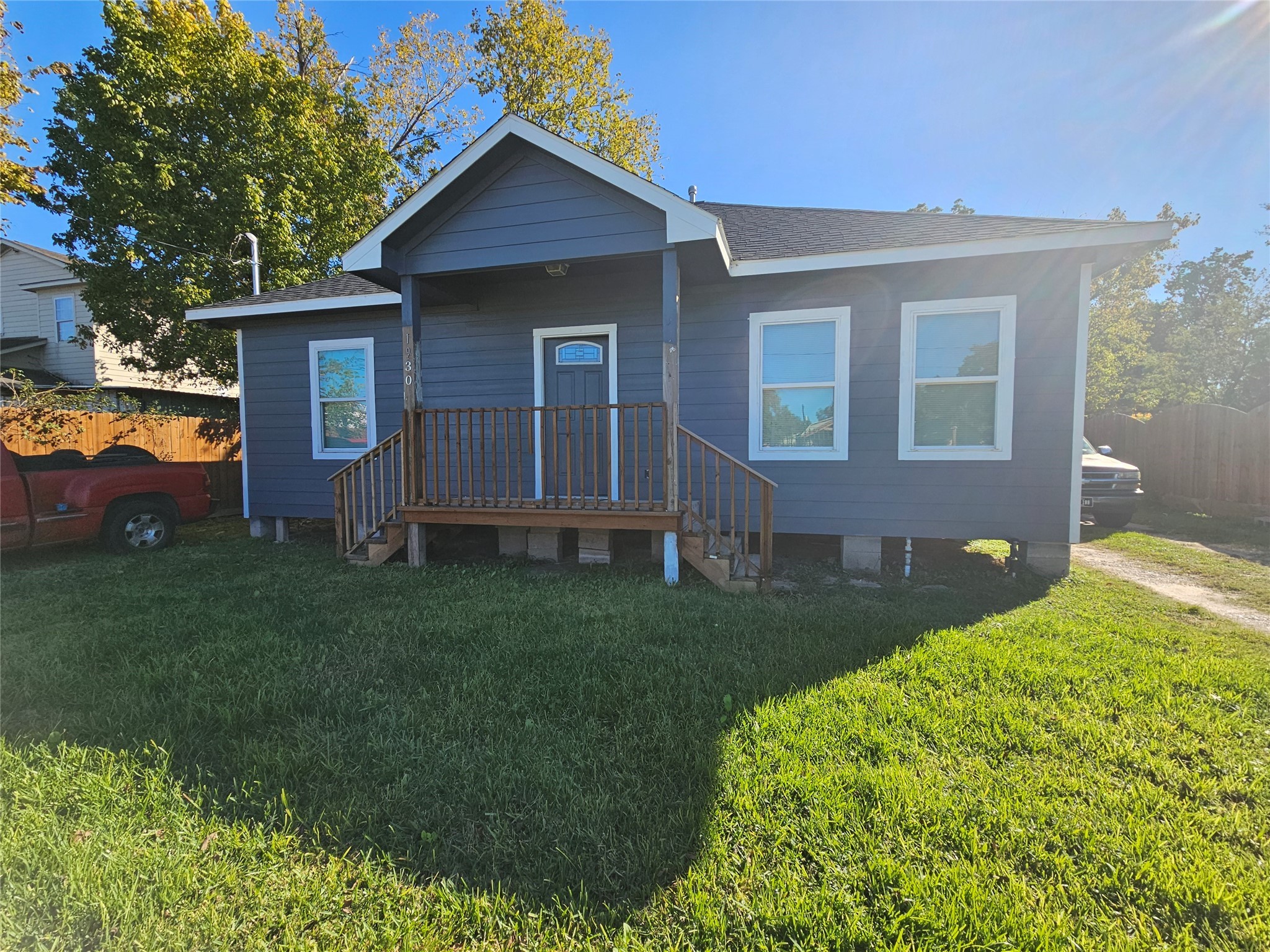 a view of backyard of house with green space
