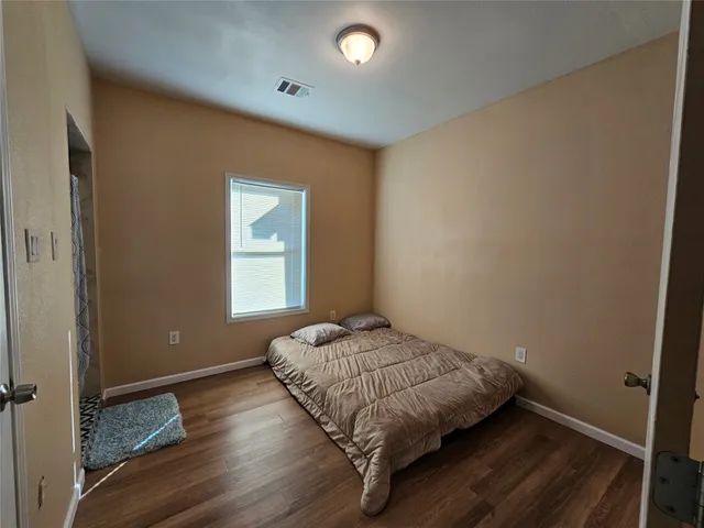 a bedroom with a bed and window