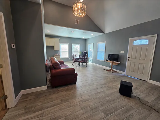 a living room with furniture and a chandelier