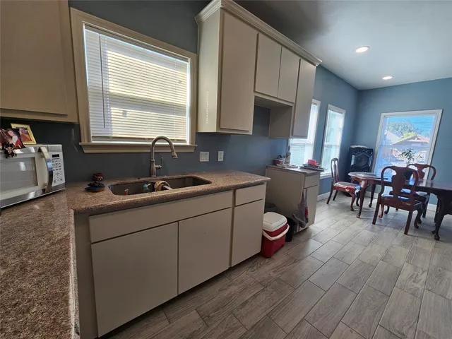 a kitchen with sink cabinets and window