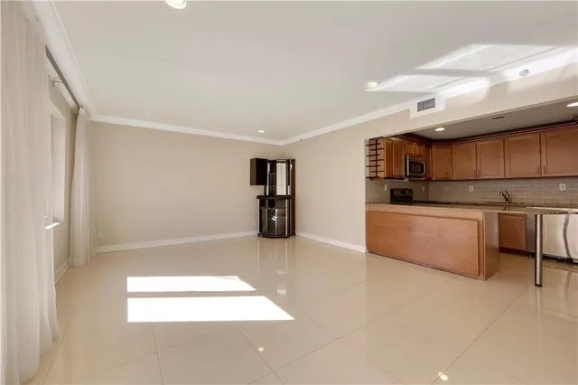 a kitchen with stainless steel appliances a refrigerator and a stove top oven
