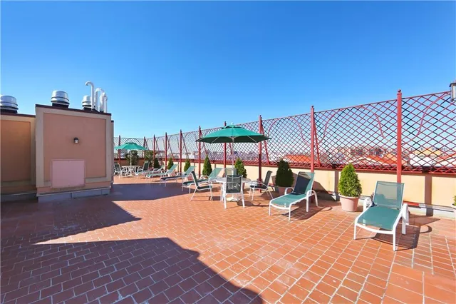 a view of a patio with a table and chairs