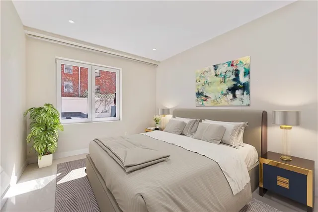 a bedroom with a bed and a potted plant