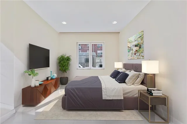 a bedroom with a bed and a flat screen tv