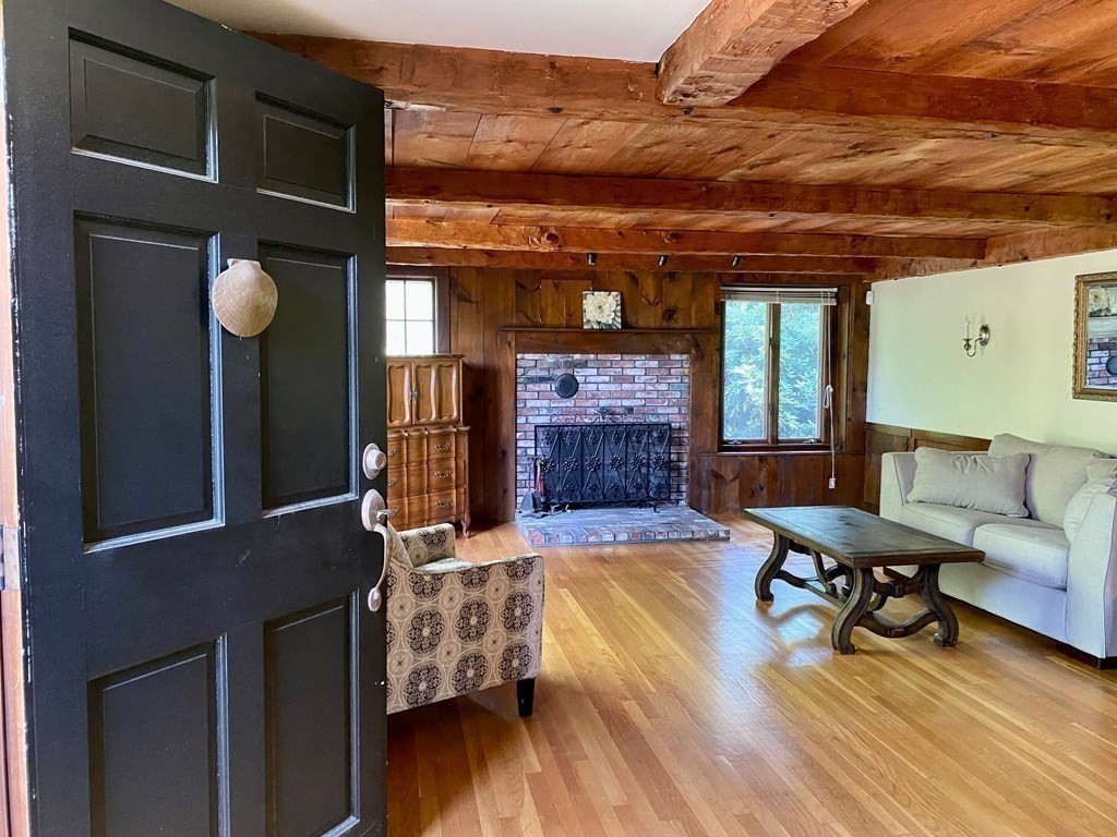 103 Clapp Road Scituate, MA 02066 - Photo 12 of 27 a living room with furniture and a fireplace
