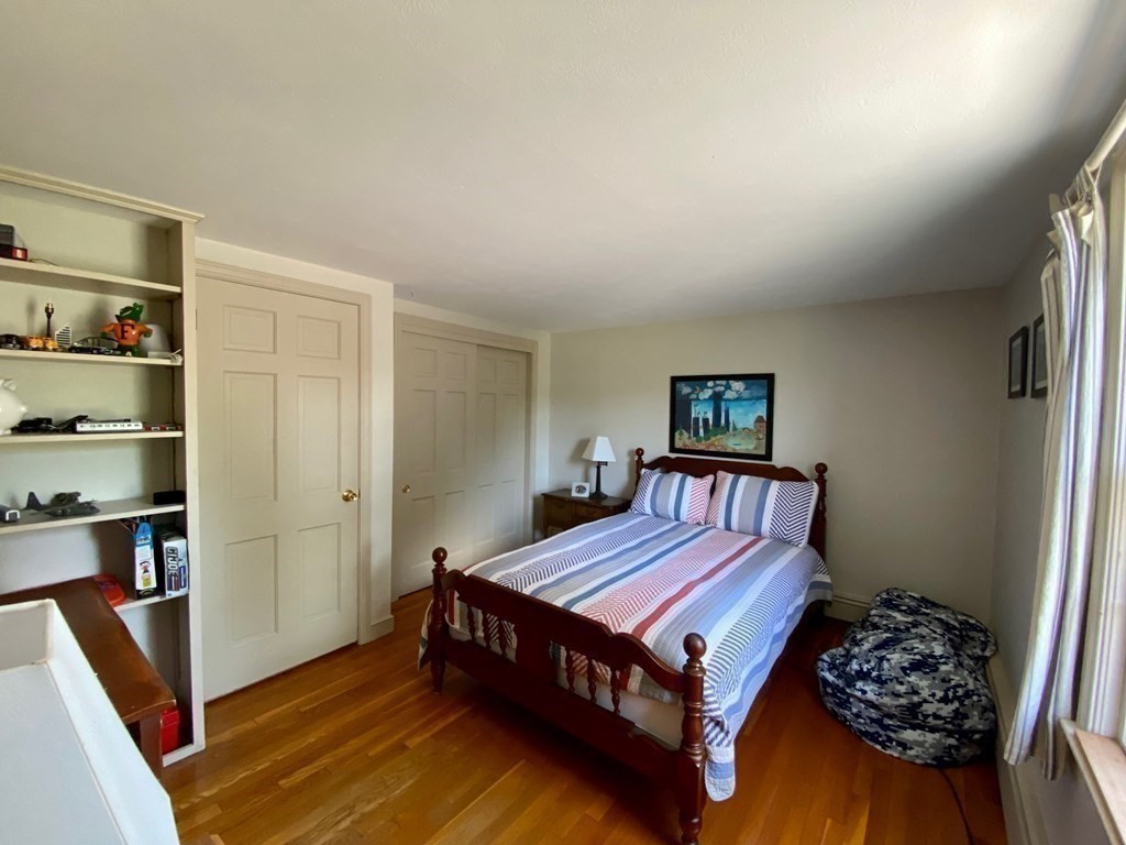 103 Clapp Road Scituate, MA 02066 - Photo 15 of 27 a bed sitting in a bedroom next to a window