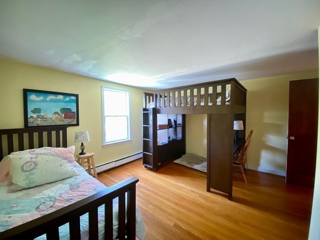 103 Clapp Road Scituate, MA 02066 - Photo 16 of 27 a bedroom with furniture and wooden floor