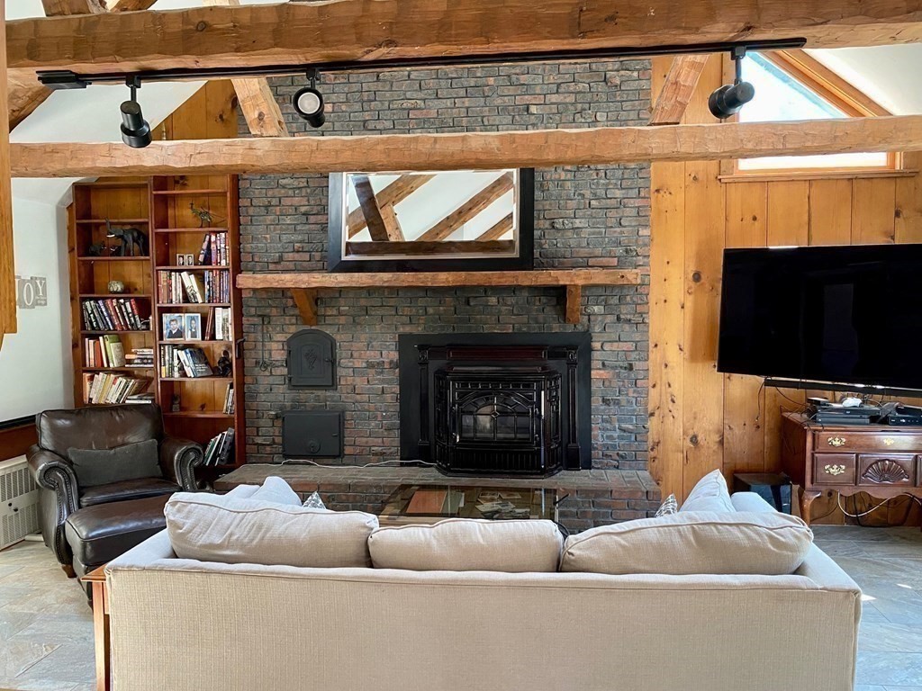 103 Clapp Road Scituate, MA 02066 - Photo 8 of 27 a living room with furniture a flat screen tv and a fireplace