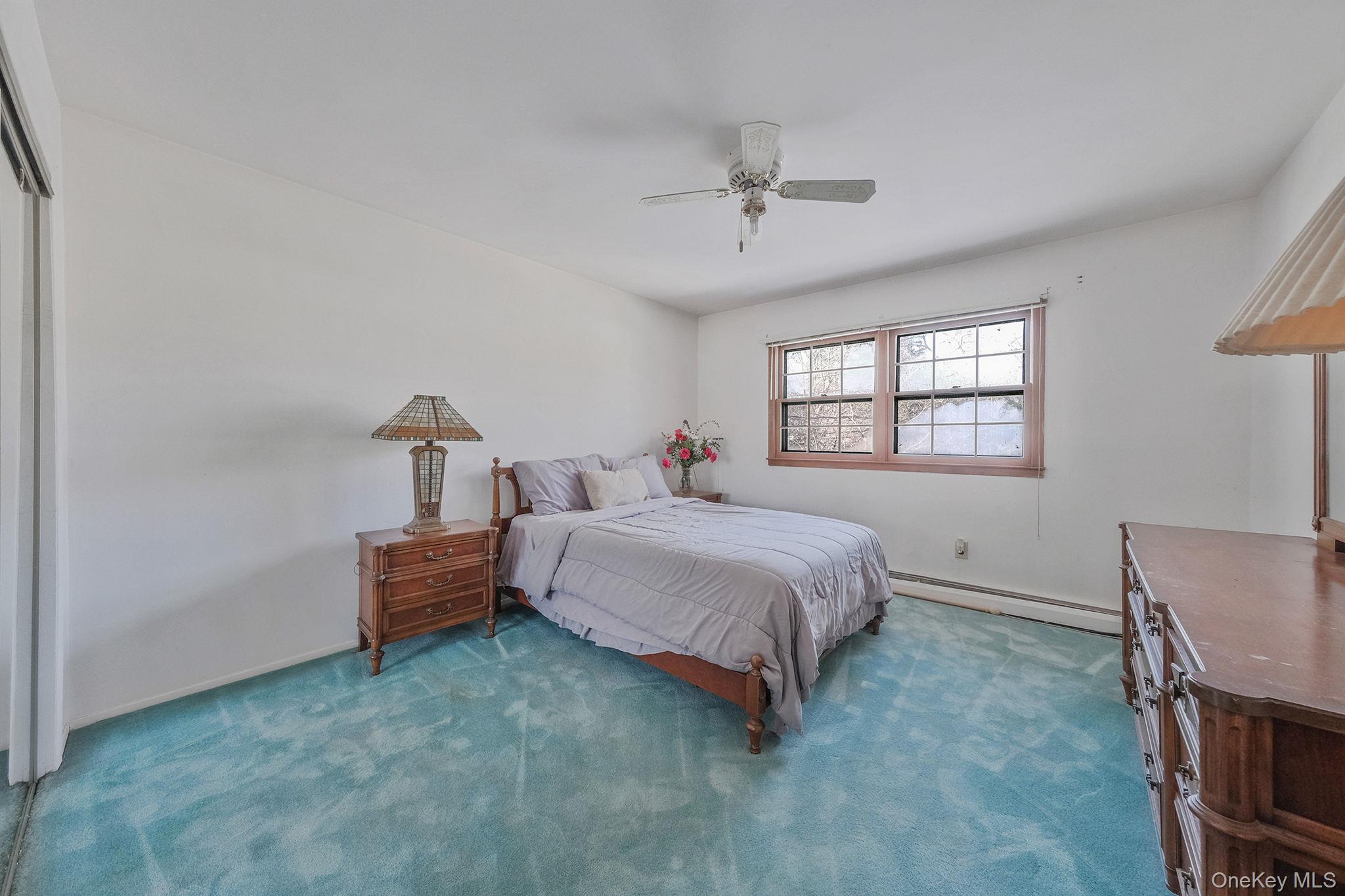 140 Seaman Neck Road Dix Hills, NY 11746 - Photo 13 of 21 a spacious bedroom with a bed and a window