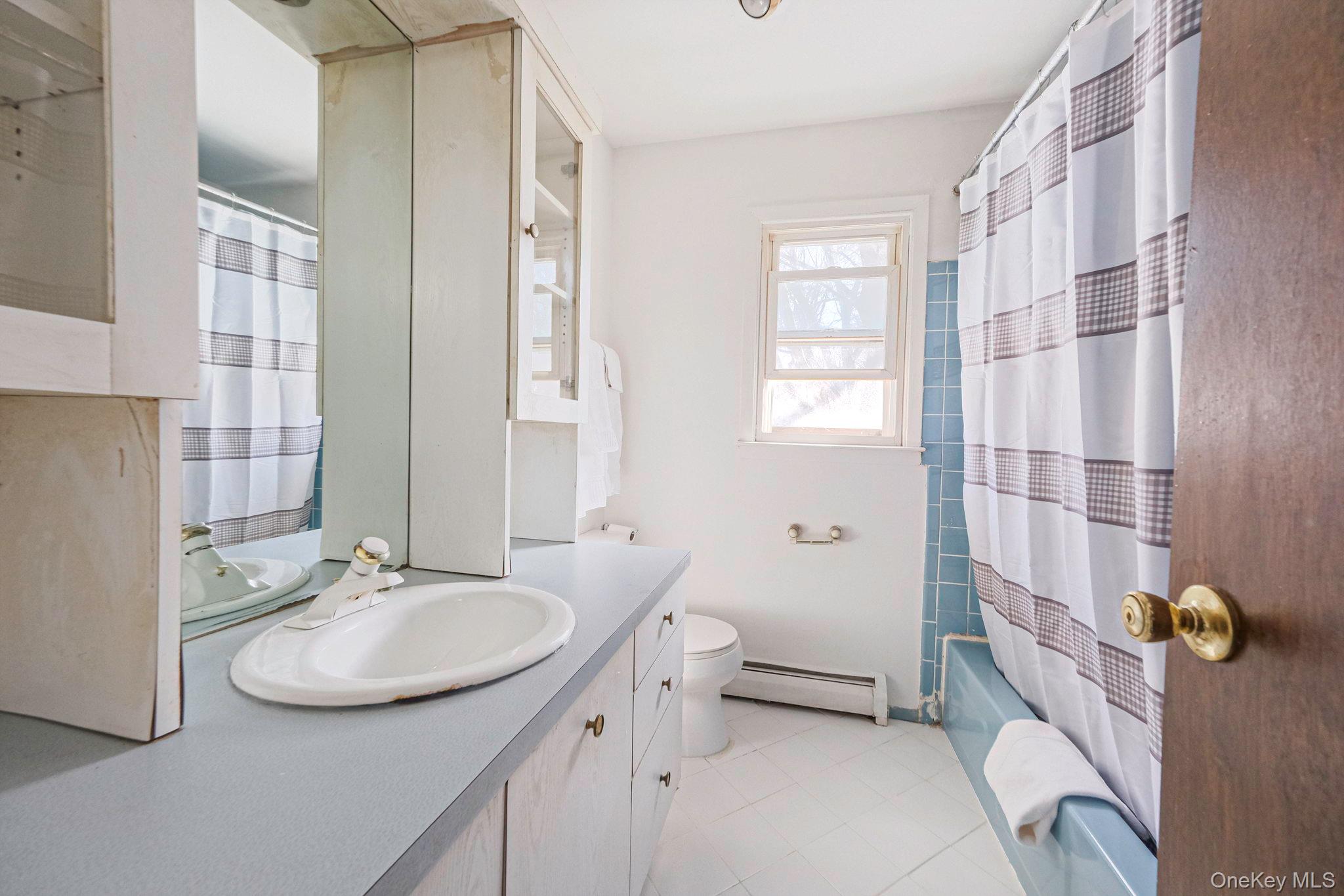 140 Seaman Neck Road Dix Hills, NY 11746 - Photo 14 of 21 a bathroom with a sink double vanity and shower