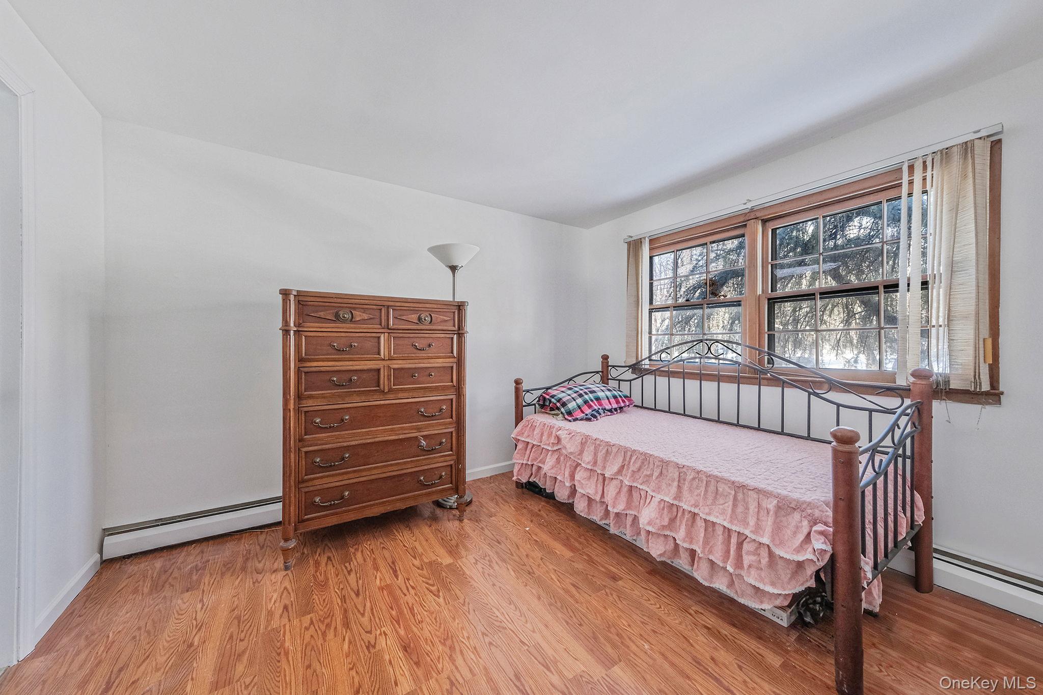 140 Seaman Neck Road Dix Hills, NY 11746 - Photo 16 of 21 a bedroom with a bed and a window
