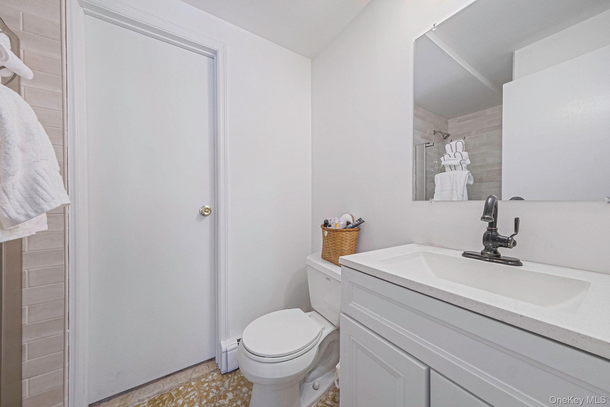 140 Seaman Neck Road Dix Hills, NY 11746 - Photo 17 of 21 a bathroom with a sink and a toilet