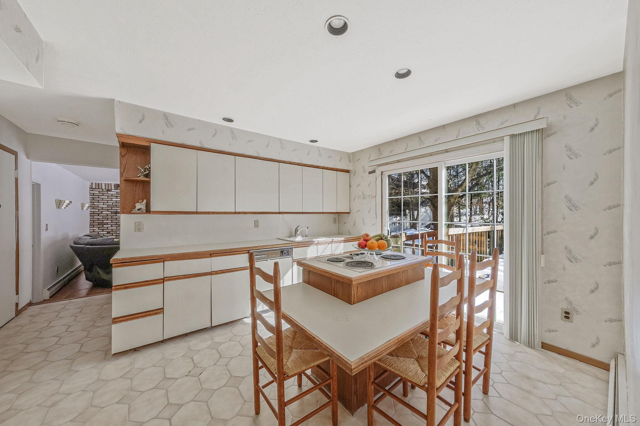 140 Seaman Neck Road Dix Hills, NY 11746 - Photo 5 of 21 a kitchen with a table and chairs in it