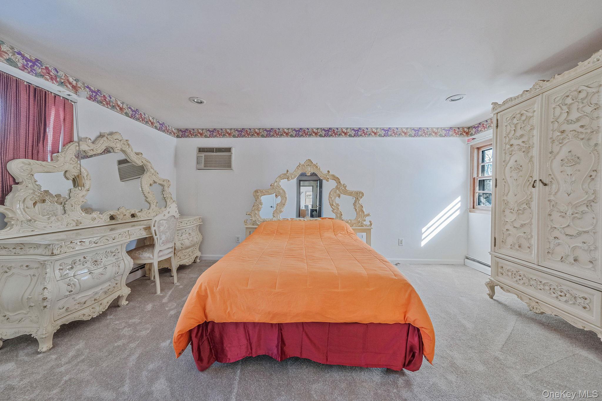 140 Seaman Neck Road Dix Hills, NY 11746 - Photo 8 of 21 a bedroom with a bed next to a window with the outer view