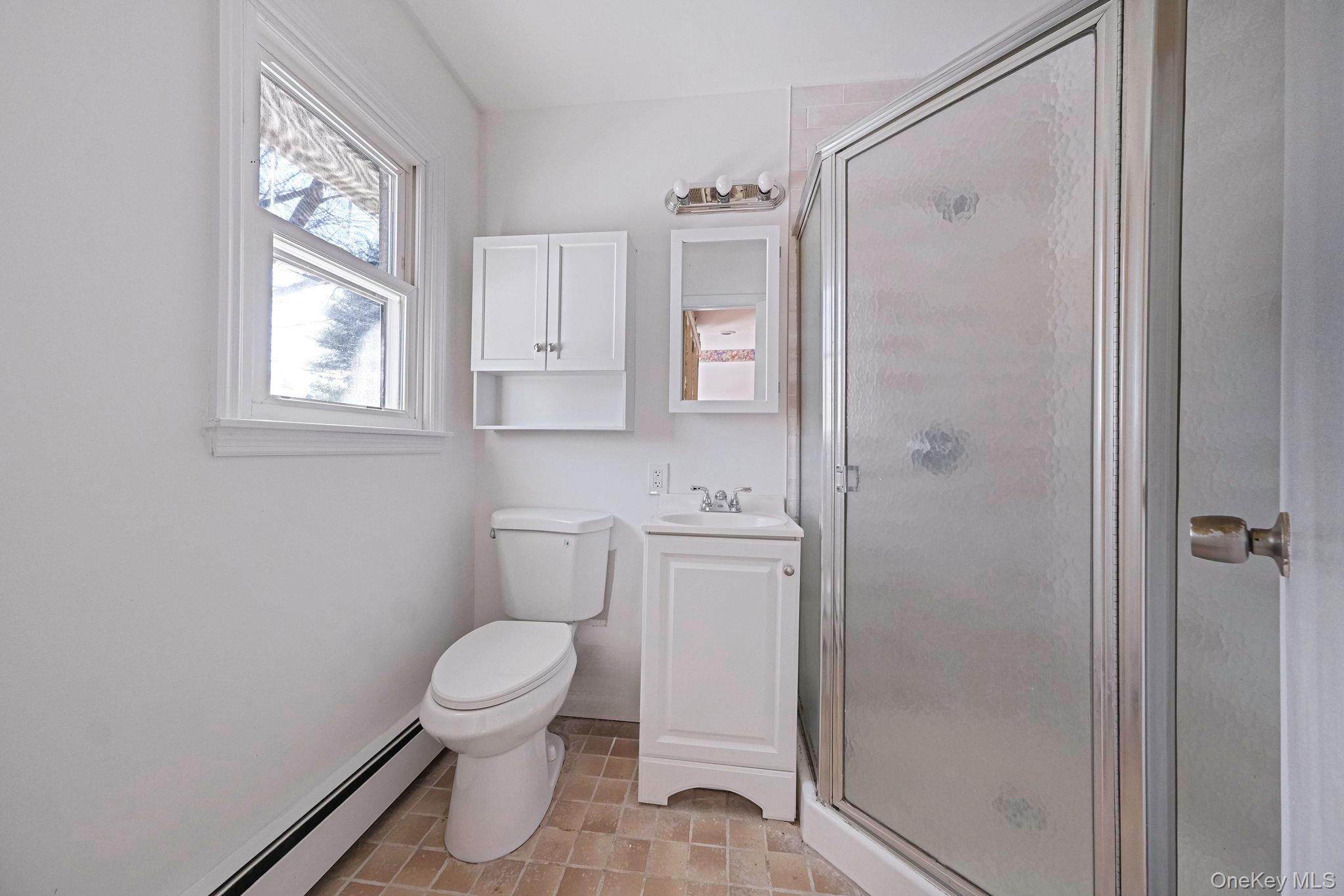 140 Seaman Neck Road Dix Hills, NY 11746 - Photo 10 of 21 a bathroom with a toilet a sink and a window