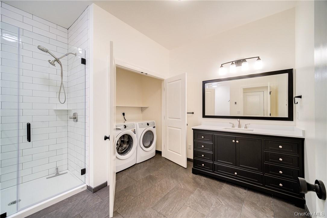 22 Lapis Drive, Unit B Beacon, NY 12508 - Photo 13 of 23 a bathroom with a sink a mirror and shower