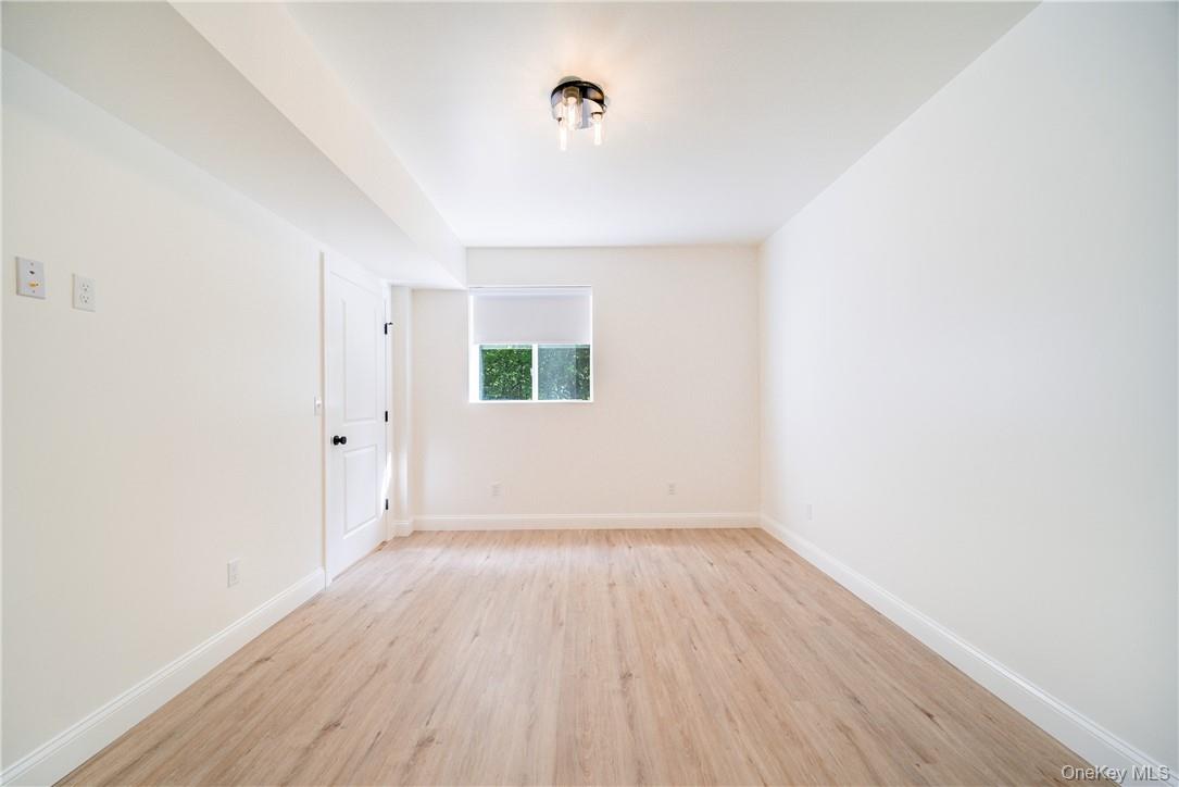 22 Lapis Drive, Unit B Beacon, NY 12508 - Photo 18 of 23 a view of an empty room with wooden floor and a window
