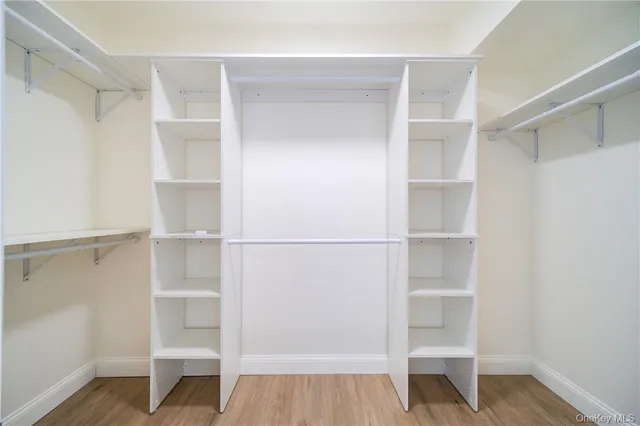 a view of walk in closet with empty racks