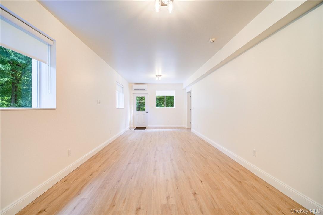 22 Lapis Drive, Unit B Beacon, NY 12508 - Photo 7 of 23 an empty room with wooden floor and windows
