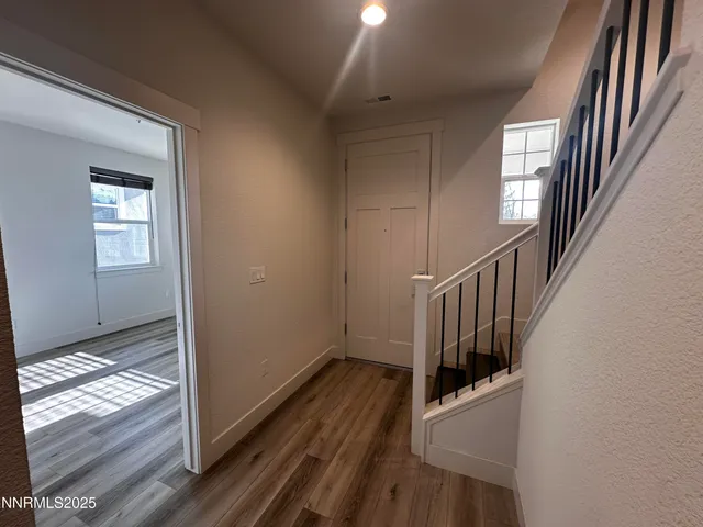 a view of entryway and hall with wooden floor