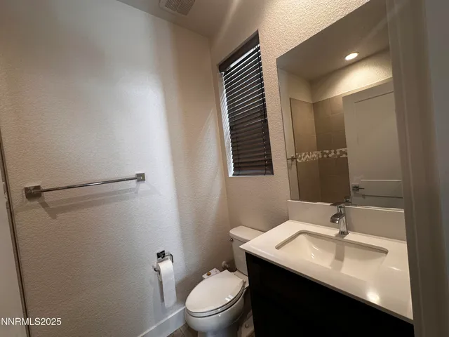 a bathroom with a sink toilet and mirror