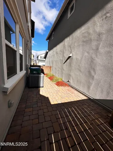 a view of an empty room with wooden floor and staircase